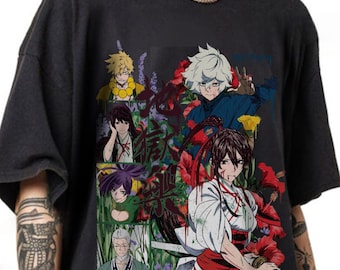 May include: A black short-sleeved t-shirt featuring a multi-panel graphic print of various anime characters. The design includes figures with distinct hair colours, red hibiscus flowers, and Japanese kanji characters overlaid on the artwork.