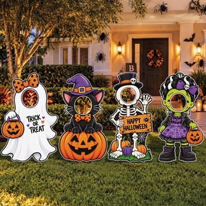 May include: Four Halloween-themed face-in-hole cutout boards featuring a white ghost holding a pumpkin, a black cat in a purple hat on a pumpkin, a skeleton in a top hat holding a Happy Halloween sign, and a green-skinned character in a dress.