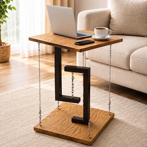 May include: A square wooden side table featuring a floating design with a top and base connected by four silver metal chains at the corners and a central black S-shaped metal support structure that appears to suspend the top surface.