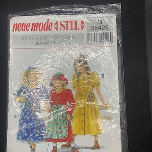 May include: A sewing pattern envelope labeled neue mode STIL 55426 featuring illustrations of three outfits for children. The designs include a blue floral dress, a red jacket with a strawberry print apron, and a yellow button-down dress with puff sleeves.