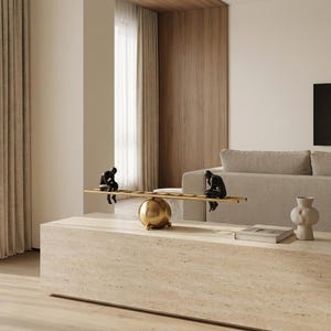 May include: A decorative sculpture featuring two dark, seated human-like figures positioned on opposite ends of a horizontal ladder-like beam, which is balanced atop a central, polished gold-toned sphere base.