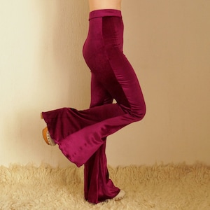 May include: A pair of wide-leg, burgundy velvet pants with a high waist.