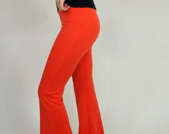 May include: A pair of red flared pants with a wide leg opening. The pants are made of a soft, stretchy fabric.