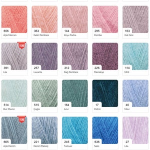 May include: A colour chart of yarn samples, with each sample labelled with a number and a colour name in Turkish. The chart is organised in rows and columns, with each row representing a different colour family. The colours range from white to black, with shades of grey, beige, pink, blue, green, and red.