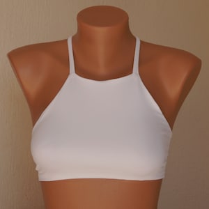 May include: White halter top with a high neckline and thin straps.