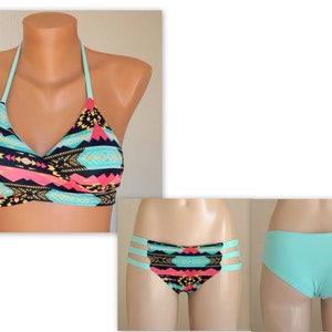 May include: A turquoise and black patterned bikini top with a halter neck strap and a matching turquoise bottom with side cutouts.
