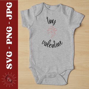 May include: A gray baby onesie with the text "tiny valentine" and a red outline of a cupid with arrows.
