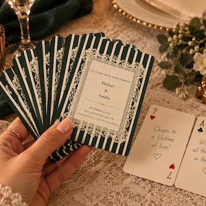 May include: A deck of custom playing cards with dark green and white vertical stripes and a white lace border. The front card reads: Together with their families, Michael & Amelia, October 30, 2027, The Grand Ballroom, Charleston, South Carolina.