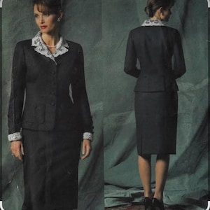 May include: A black two-piece suit featuring a long-sleeved jacket with a white lace collar and matching lace cuffs, paired with a knee-length pencil skirt. The jacket has a button-front closure and a subtle vertical pinstripe pattern throughout.