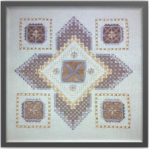 May include: A framed embroidery design featuring a geometric pattern with a central star shape. The design is worked in shades of brown, beige, and gray on a light blue background.