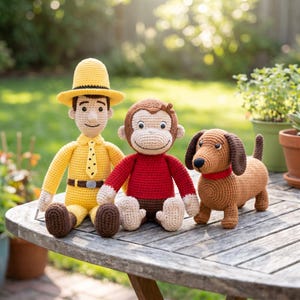 May include: Three handmade crochet dolls featuring a person in a yellow outfit and hat with a black tie, a brown monkey in a red shirt, and a brown dachshund dog with a red collar. The figures are crafted with yarn and have stitched facial features.