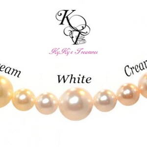 May include: A row of pearls in different shades of white, cream, and creamrose. The pearls are arranged from left to right in order of color, with the darkest shade on the left and the lightest shade on the right. The pearls are labeled with their respective colors.