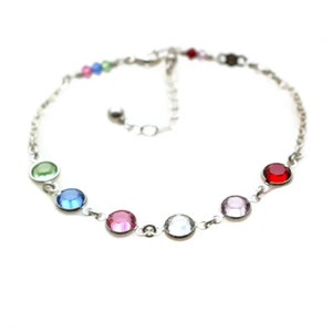 Birthstone bracelet with six stones represented with 6mm round rhodium plated channel set crystal links. The crystals connect to diamond cut sterling silver cable chain, which closes with a lobster claw clasp with extender.