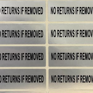 May include: A sheet of eight rectangular silver stickers arranged in two columns. Each sticker features a metallic silver background with the text NO RETURNS IF REMOVED printed in bold, black, sans-serif capital letters centred on each label.