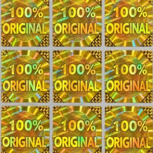 May include: A grid of nine square holographic stickers, each featuring a central sphere with a mesh pattern. The text 100% ORIGINAL is printed in bold yellow letters across the centre of each sticker, surrounded by a repeating pattern of the word ORIGINAL.