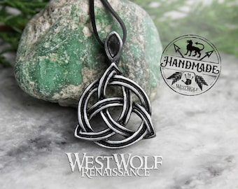 May include: A silver Celtic knot pendant necklace with a black cord. The pendant is in the shape of a triangle with three interlocked circles. The pendant is on a white marble surface with a green stone in the background. The text "Handmade" and "Westwolf Renaissance" is visible in the image.