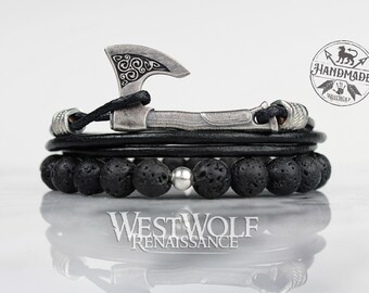 May include: Black leather bracelet with black lava rock beads and a silver axe charm. The bracelet has a silver clasp and is handmade. The text "HANDMADE" is visible on the charm.