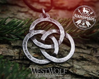 May include: A silver Celtic knot pendant necklace with a textured finish. The pendant is in the shape of three interlocking circles. The necklace is on a dark brown wooden surface.