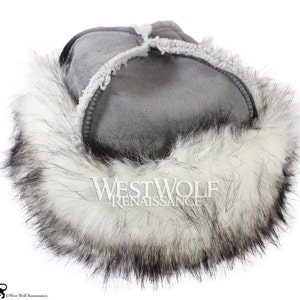 May include: Gray suede hat with a white faux fur trim. The hat has a  "Westwolf Renaissance" logo on the side.