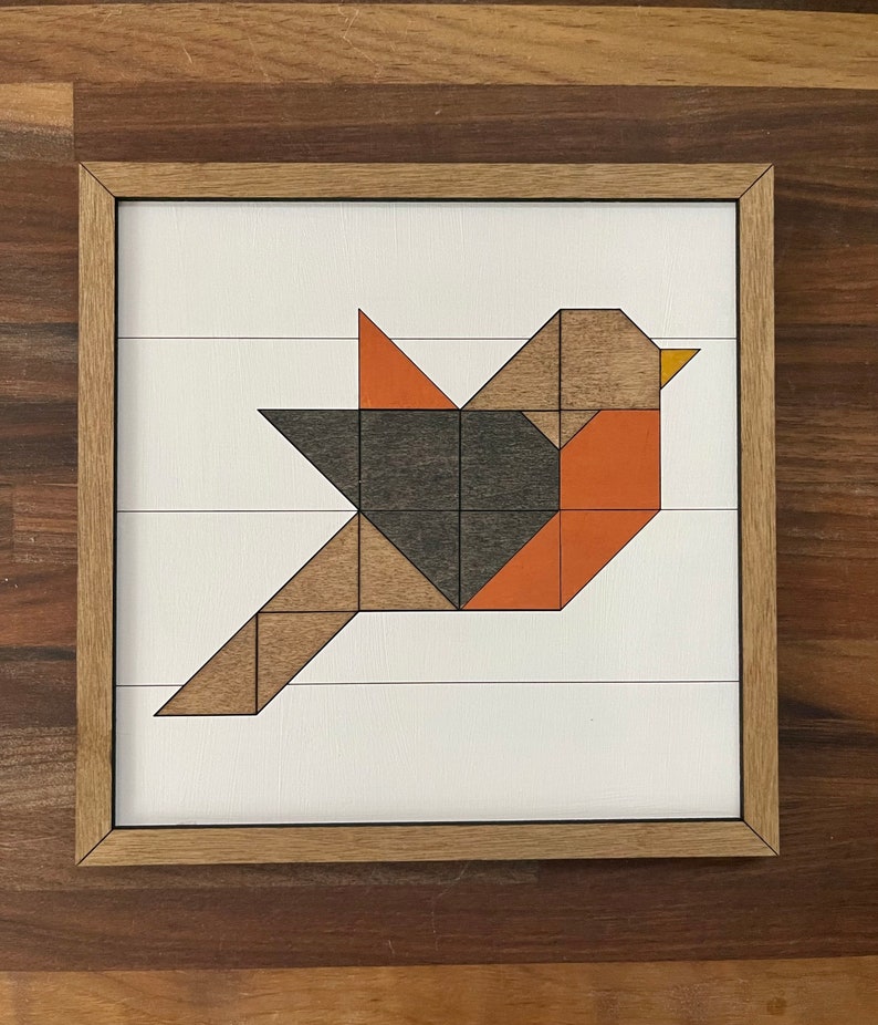 May include: Geometric wooden bird wall art with a brown, orange, and black color scheme. The bird is made of individual wooden pieces that are assembled to create a geometric design.