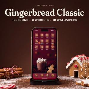 Gingerbread Classic Christmas phone theme by Frenetiq Design: a smartphone in a black stand on a dark walnut table dusted with powdered sugar, next to a small iced gingerbread house, gingerbread cookies, cinnamon sticks and star anise. The home screen shows white-iced gingerbread icons on cranberry red tiles over the hot cocoa and gingerbread man wallpaper. Text: 120 icons, 8 widgets, 10 wallpapers.