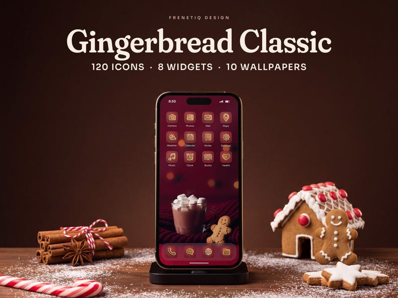 Gingerbread Classic Christmas phone theme by Frenetiq Design: a smartphone in a black stand on a dark walnut table dusted with powdered sugar, next to a small iced gingerbread house, gingerbread cookies, cinnamon sticks and star anise. The home screen shows white-iced gingerbread icons on cranberry red tiles over the hot cocoa and gingerbread man wallpaper. Text: 120 icons, 8 widgets, 10 wallpapers.