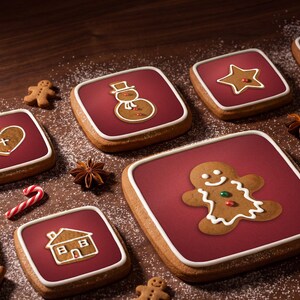 Close-up of Gingerbread Classic gingerbread app icons set into iced cookie tiles, with star anise and cinnamon on walnut.