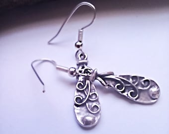 Rustic casual silver tone drop earrings with ornate scroll design. Visible from either side.