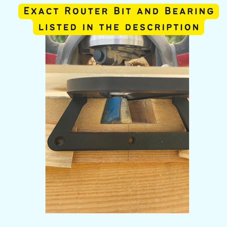 May include: A close-up of a router bit and bearing attached to a router. The router bit is cutting a groove in a piece of wood. The bearing is guiding the router bit along the edge of the wood.