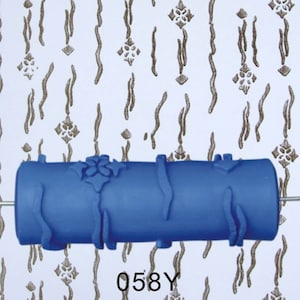 May include: Blue paint roller with a pattern of wavy lines and floral designs. The roller is shown against a white background with a sample of the pattern created by the roller. The text "058Y" is printed below the roller.