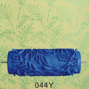 May include: Blue paint roller with a floral design. The roller is 7 inches long and has a 4-inch diameter. The design features leaves and berries. The roller is labeled "044Y".