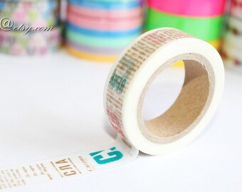 May include: A white washi tape roll with a printed design featuring blue and gold text. The text reads "СЛА" and "С.Петербург". The tape is partially unrolled, revealing the design.