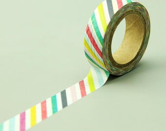 May include: A roll of colourful washi tape with a diagonal stripe pattern in shades of blue, green, yellow, pink, and red. The tape is partially unrolled, showing the pattern.