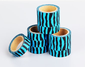 May include: A stack of blue and black striped washi tape rolls. The tape is decorative and can be used for crafts, scrapbooking, and other projects.