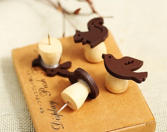 May include: Four wooden push pins with animal designs. The pins are brown and have a wooden base. The designs are a squirrel, a rabbit, a bird, and a bird. The pins are on a brown box with the text "Display Push" and Japanese text.