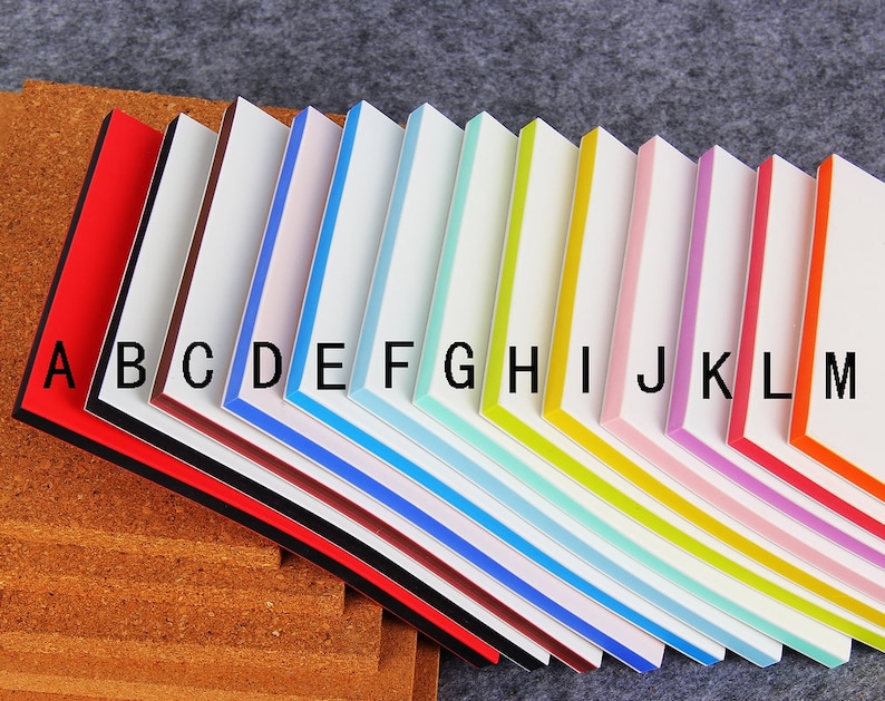 May include: A set of 13 colorful sticky notes with black borders and white centers. The notes are labeled with letters from A to M.