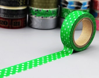 May include: A roll of green washi tape with white polka dots. The tape is unrolled and the roll is visible.