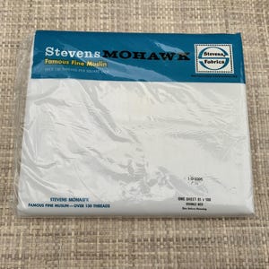 May include: A package of Stevens Mohawk Famous Fine Muslin, a white fabric sheet for a double bed. The blue and white label states over 130 threads per square inch and includes the text one sheet 81 x 108, double bed, see above hemming.