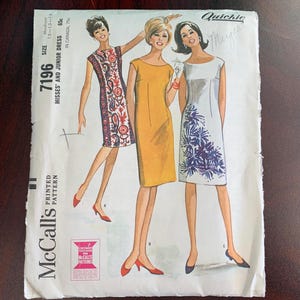 May include: Vintage McCall's sewing pattern for a misses' and junior dress. The pattern number is 7196 and the size is medium. The pattern is printed on white paper with a black and white illustration of three women wearing different styles of dresses. The dresses are all knee-length and have a simple, classic design.