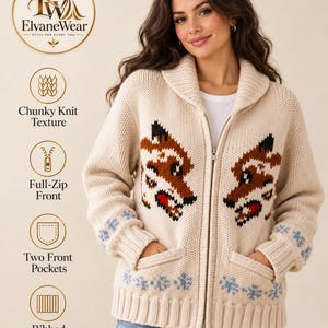 May include: A beige chunky knit cardigan featuring a full-zip front, two front pockets, and ribbed cuffs and hem. The sweater displays a brown and black fox head graphic on each side of the zipper and light blue snowflake patterns near the hem.