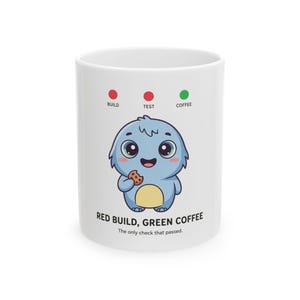 May include: A white ceramic mug featuring a cartoon blue creature eating a cookie. Above the creature are three circles labelled BUILD, TEST, and COFFEE, with the first two red and the third green. Text below reads RED BUILD, GREEN COFFEE. The only check that passed.