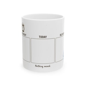 May include: A white ceramic mug featuring a graphic with three vertical rectangular boxes labeled YESTERDAY, TODAY, and BLOCKED. An alarm clock icon appears above YESTERDAY. The text Nothing moved. is printed in black below the center box.
