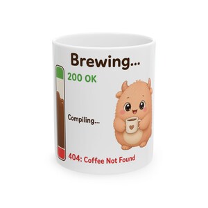 May include: A white ceramic mug featuring a vertical progress bar, the text Brewing, 200 OK, Compiling, and 404: Coffee Not Found. A small, light brown, furry creature with horns is illustrated holding a tiny white mug with a heart icon on it.