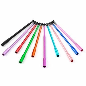 May include: A collection of ten slender, cylindrical metal tubes arranged in a fan shape. Each tube features a smooth, solid-colored finish in black, lavender, red, green, orange, purple, turquoise, light pink, blue, and hot pink.