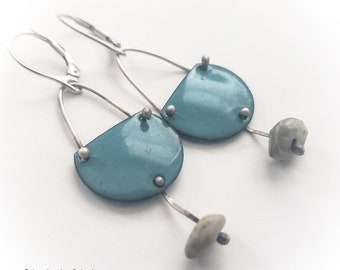 May include: A pair of silver earrings with a teal blue enamel half-circle pendant and a small grey stone hanging from each earring.