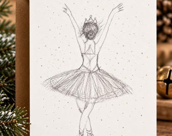 May include: A white greeting card featuring a black pencil sketch of a ballerina seen from behind. The figure wears a tutu, a crown, and ballet slippers with arms raised. Small gold and silver dots are scattered across the white background.