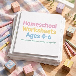 May include: A stack of white paper worksheets titled Homeschool Worksheets Ages 4-6, Trace Letters & Numbers, Counting, 32 Pages PDF. The stack is surrounded by colorful crayons and wooden blocks featuring letters A, B, C and numbers 1, 2, 3.