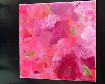 May include: A square canvas painting featuring an abstract composition of layered brushstrokes in various shades of pink, magenta, and fuchsia, with small accents of light green and orange visible throughout the textured paint application.