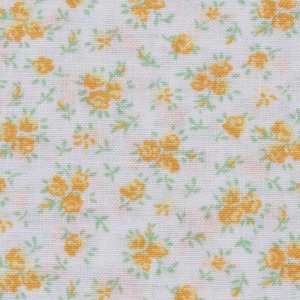 May include: Close-up of a white fabric with a repeating pattern of small yellow roses and green leaves. The floral design is evenly distributed across the surface, creating a delicate and vintage aesthetic. The fabric appears to be cotton or a similar lightweight material.