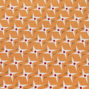 May include: Orange and white geometric fabric with a repeating pattern of stars and small red dots.